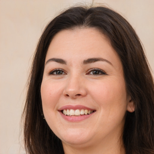 Joyful white young-adult female with long  brown hair and brown eyes