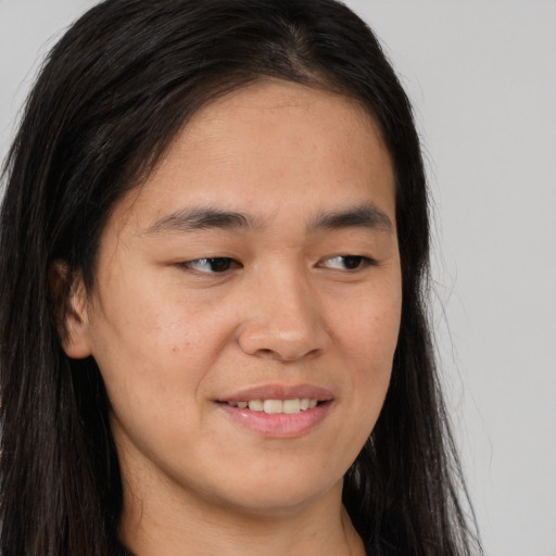 Joyful asian young-adult male with long  brown hair and brown eyes
