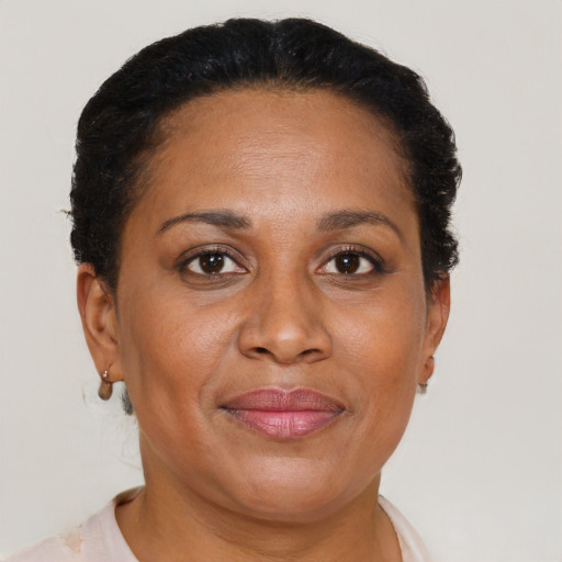 Joyful black adult female with short  brown hair and brown eyes