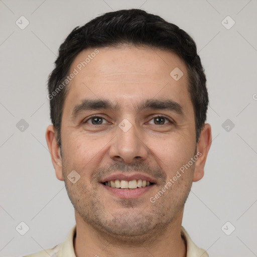 Joyful white young-adult male with short  black hair and brown eyes