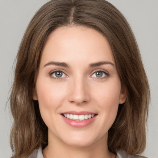 Joyful white young-adult female with medium  brown hair and green eyes