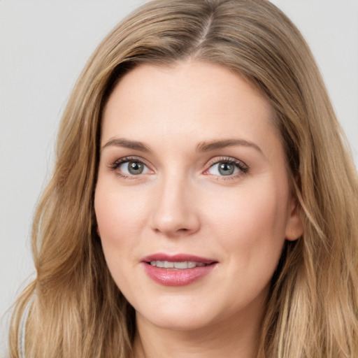 Joyful white young-adult female with long  brown hair and green eyes