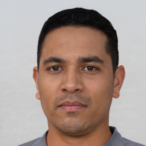 Neutral latino young-adult male with short  black hair and brown eyes