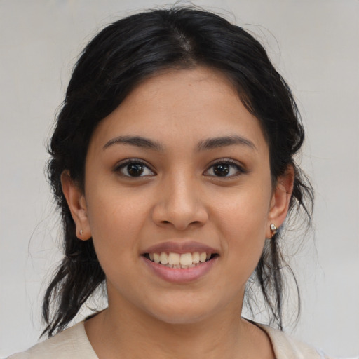 Joyful latino young-adult female with medium  brown hair and brown eyes