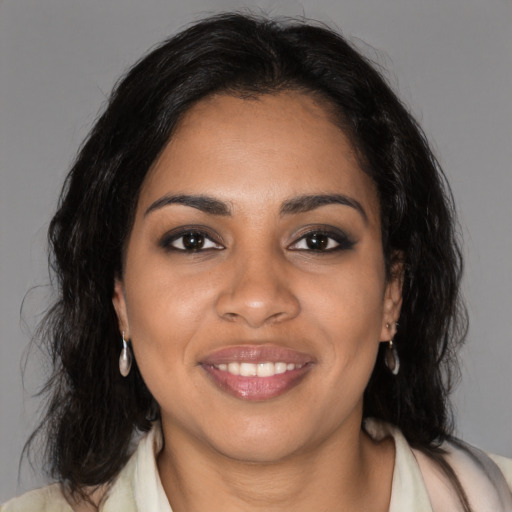 Joyful black young-adult female with medium  brown hair and brown eyes