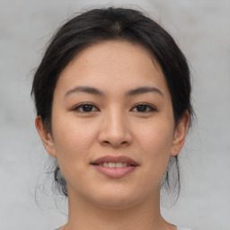 Joyful asian young-adult female with medium  brown hair and brown eyes