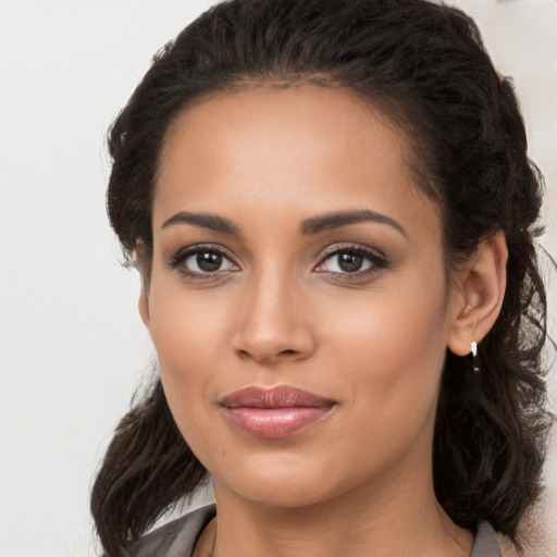 Joyful latino young-adult female with long  brown hair and brown eyes