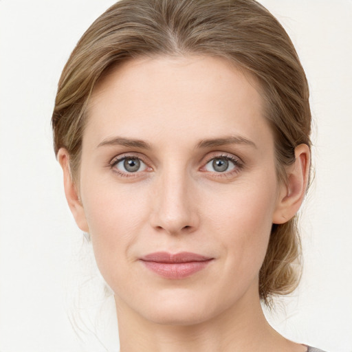 Joyful white young-adult female with medium  brown hair and blue eyes