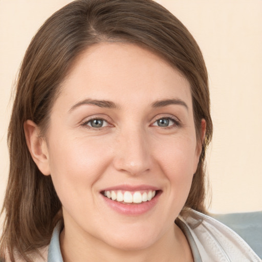 Joyful white young-adult female with medium  brown hair and grey eyes