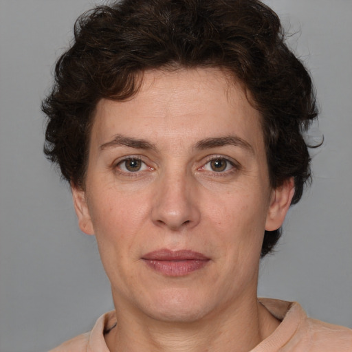 Joyful white adult female with short  brown hair and brown eyes