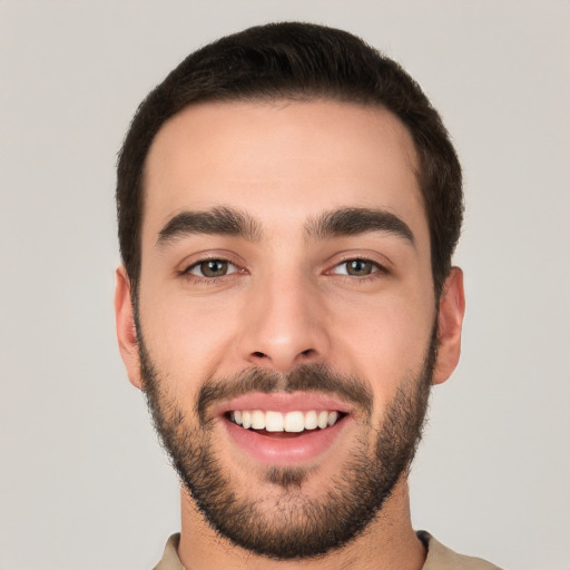 Joyful white young-adult male with short  black hair and brown eyes