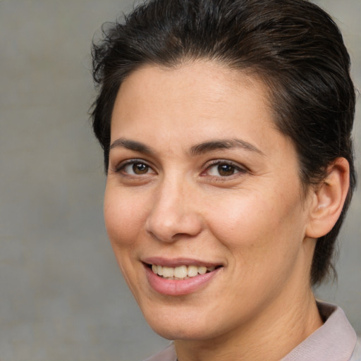 Joyful white adult female with medium  brown hair and brown eyes