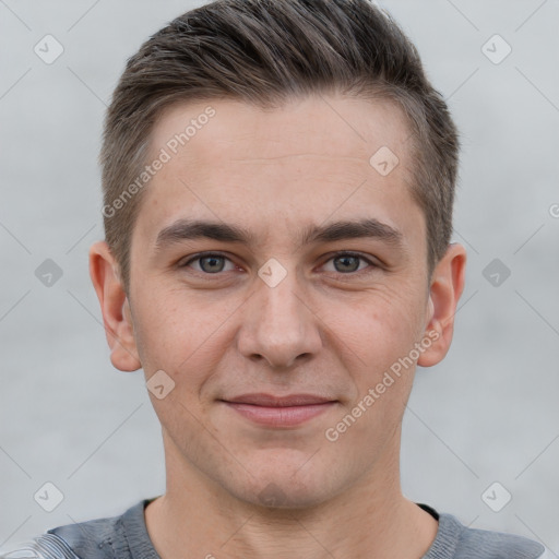 Joyful white young-adult male with short  brown hair and grey eyes