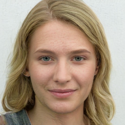 Joyful white young-adult female with long  brown hair and green eyes