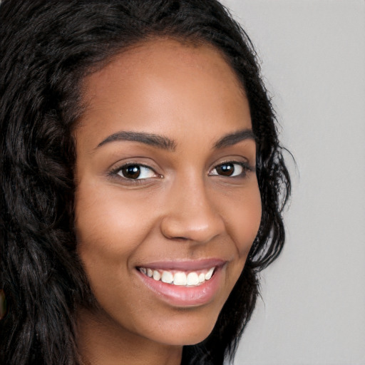 Joyful latino young-adult female with long  brown hair and brown eyes