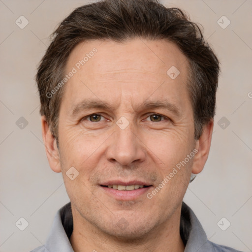 Joyful white adult male with short  brown hair and brown eyes