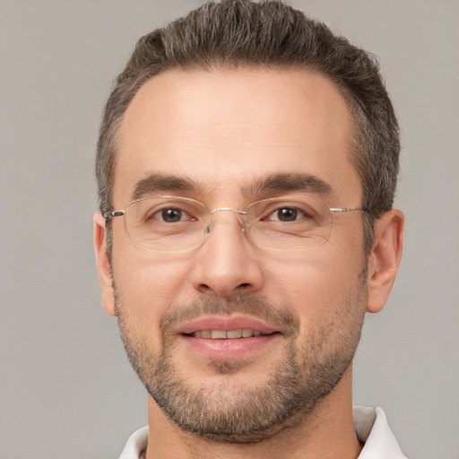 Joyful white adult male with short  brown hair and brown eyes