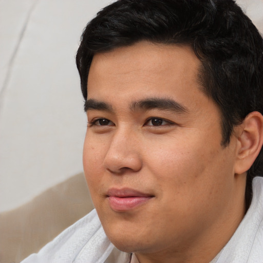 Joyful asian young-adult male with short  black hair and brown eyes