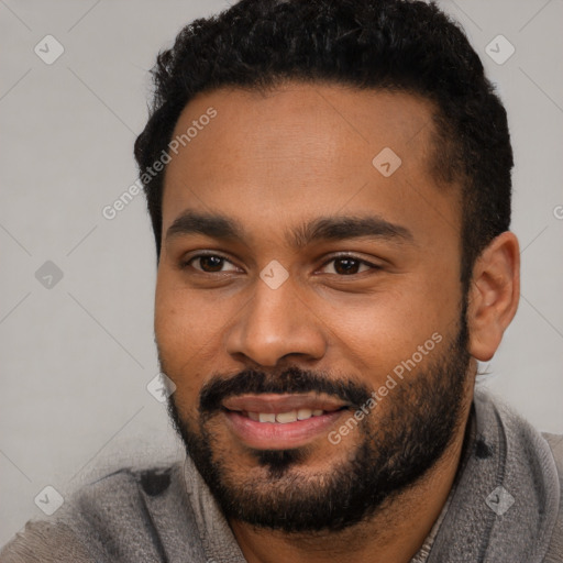 Joyful black young-adult male with short  black hair and brown eyes