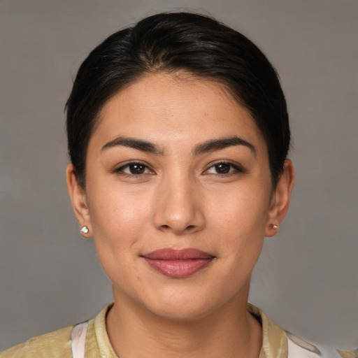 Joyful latino young-adult female with medium  brown hair and brown eyes