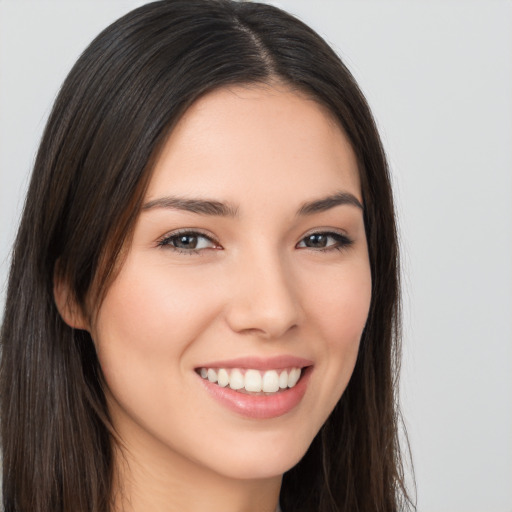 Joyful white young-adult female with long  brown hair and brown eyes