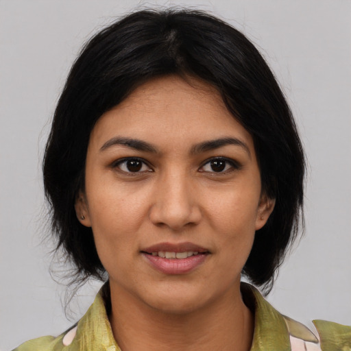 Joyful white young-adult female with medium  black hair and brown eyes
