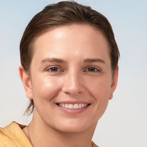 Joyful white young-adult female with short  brown hair and grey eyes