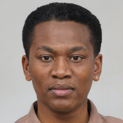 Joyful black young-adult male with short  black hair and brown eyes