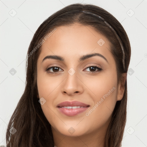 Joyful latino young-adult female with long  brown hair and brown eyes