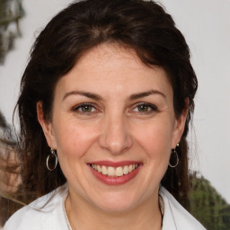 Joyful white adult female with medium  brown hair and brown eyes