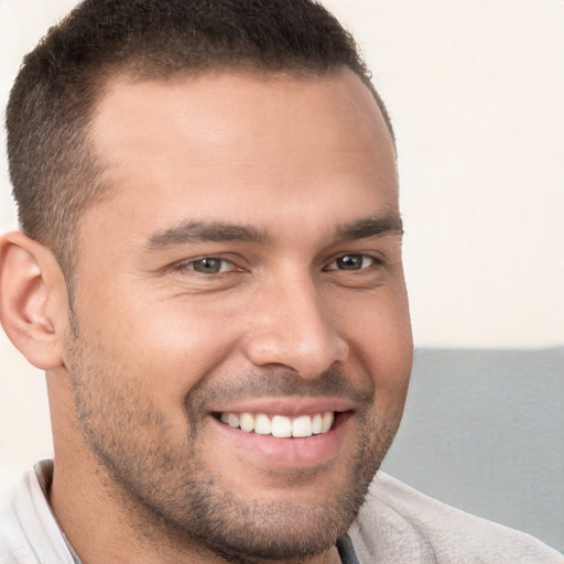 Joyful white young-adult male with short  brown hair and brown eyes