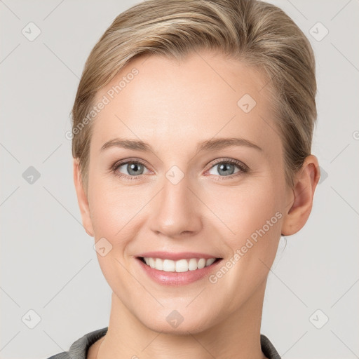 Joyful white young-adult female with short  brown hair and grey eyes