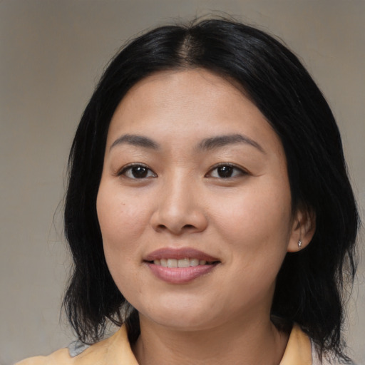 Joyful asian young-adult female with medium  black hair and brown eyes