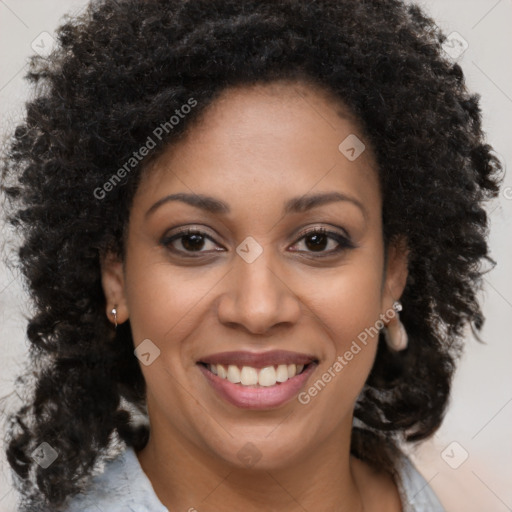 Joyful black young-adult female with long  brown hair and brown eyes