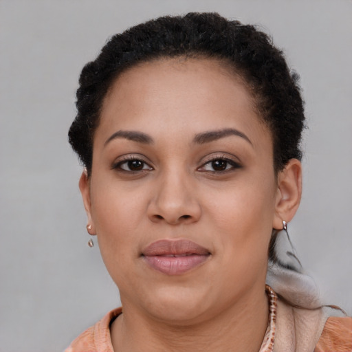 Joyful black young-adult female with short  brown hair and brown eyes