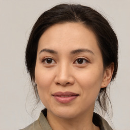 Joyful asian young-adult female with medium  brown hair and brown eyes