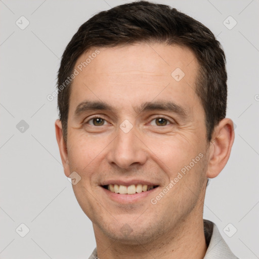 Joyful white adult male with short  brown hair and brown eyes