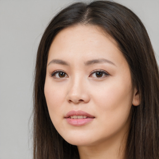 Joyful asian young-adult female with long  brown hair and brown eyes