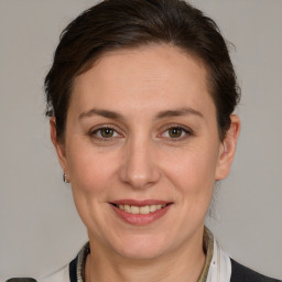 Joyful white adult female with medium  brown hair and brown eyes