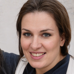 Joyful white adult female with medium  brown hair and brown eyes