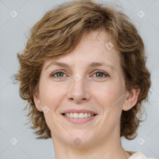 Joyful white young-adult female with medium  brown hair and green eyes