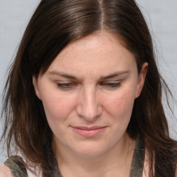 Joyful white adult female with long  brown hair and brown eyes