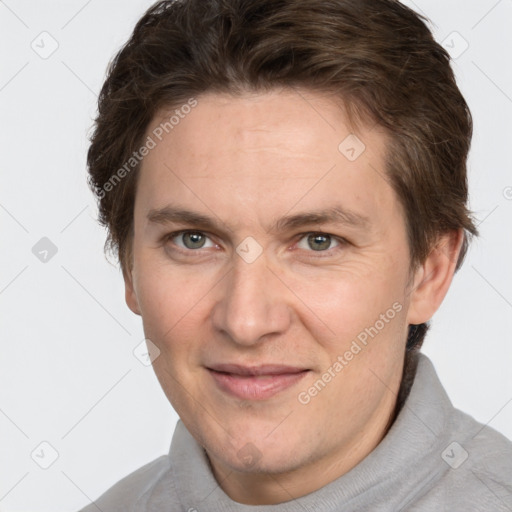 Joyful white adult male with short  brown hair and grey eyes