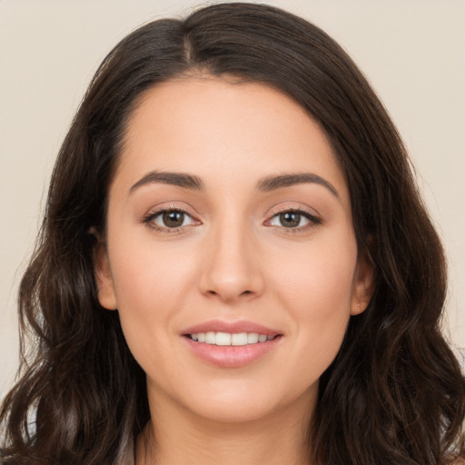 Joyful white young-adult female with long  brown hair and brown eyes