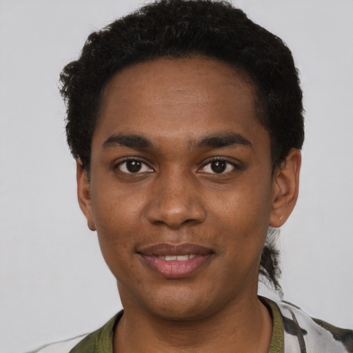 Joyful black young-adult male with short  black hair and brown eyes