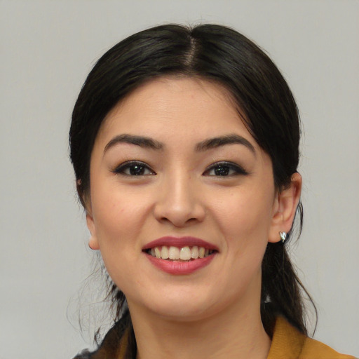 Joyful white young-adult female with medium  black hair and brown eyes