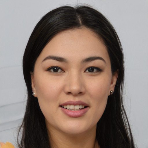 Joyful asian young-adult female with long  brown hair and brown eyes