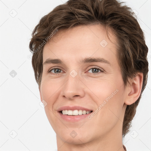 Joyful white young-adult female with short  brown hair and grey eyes