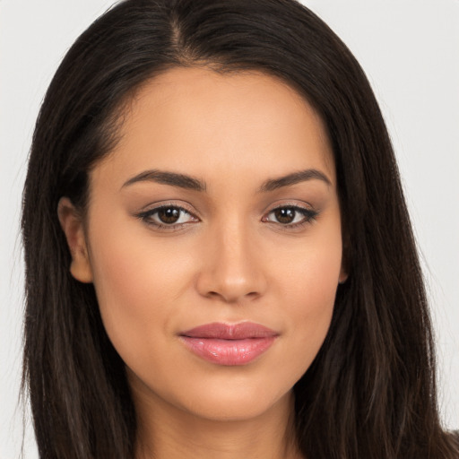 Joyful latino young-adult female with long  brown hair and brown eyes