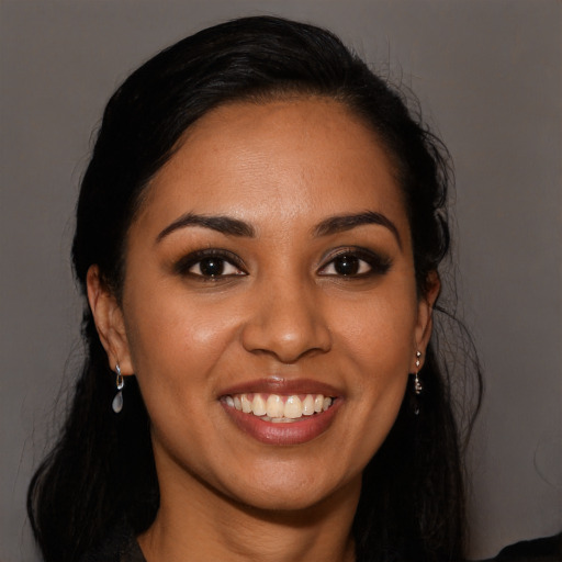Joyful latino young-adult female with long  black hair and brown eyes